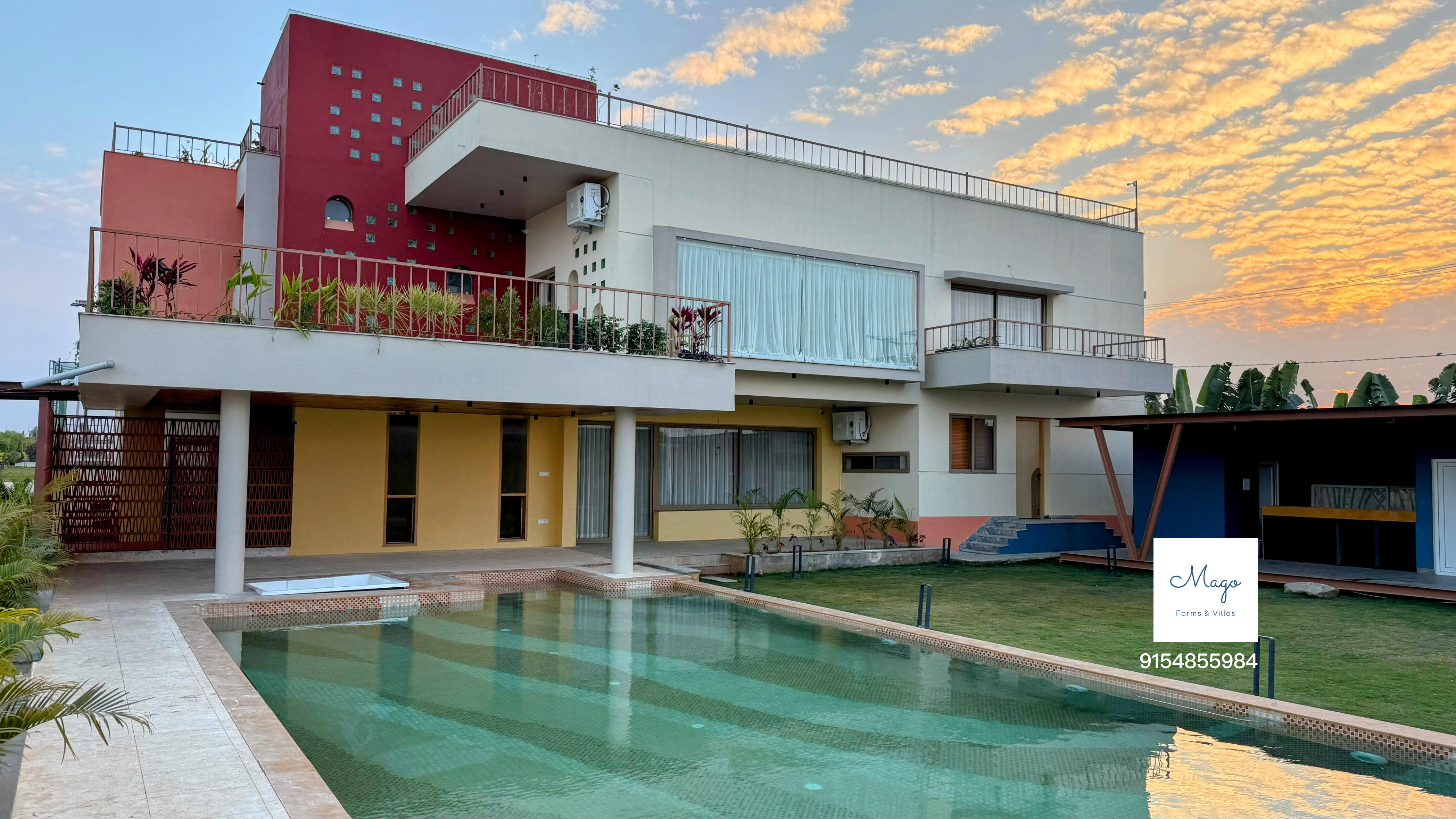 Villa exterior with pool at dusk